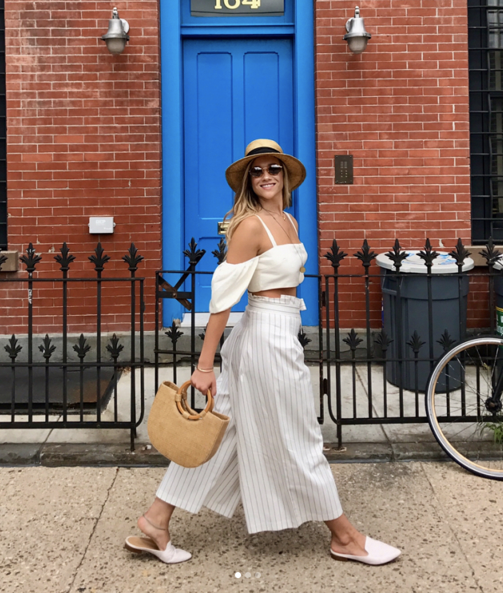 Lucy McBride founder of Hood Hippie Vintage walking down the street in NYC wearing stylish vintage outfit.