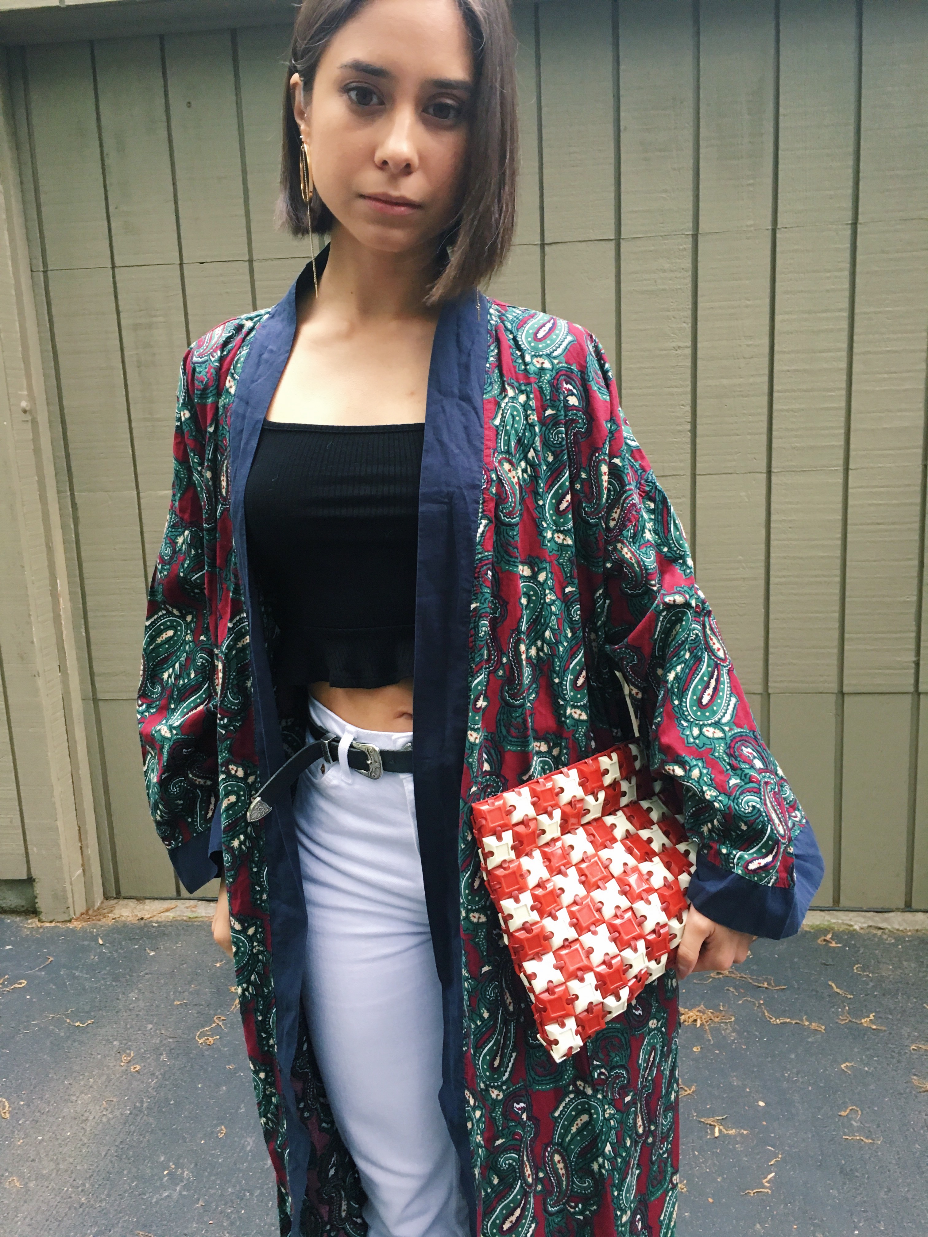 Fashion blogger That Time I Wore holds a vintage plastic tile clutch purse.